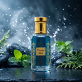 A rectangular glass perfume bottle filled with blue liquid, featuring gold ornamental patterns and a shiny gold cap, standing on a dark wet surface with greenery and stones in the background.