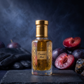 A faceted glass bottle of Finashok Musk perfume with a gold cap and ornate gold label, displayed on a dark slate board with plums, a black glove, and dark stones against a smoky dark blue background.